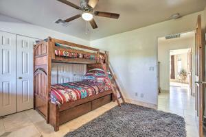 a bedroom with a bunk bed and a ceiling fan at Spacious Glendale Home with Outdoor Kitchen! in Glendale +36 photos