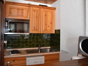 a kitchen with a sink and a microwave at Studio Pralognan-la-Vanoise, 1 pièce, 4 personnes - FR-1-464-71 in Pralognan-la-Vanoise