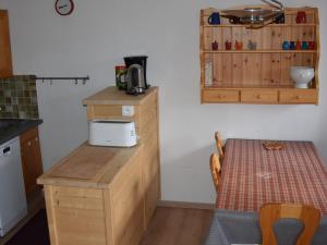 une petite cuisine avec une table et un four micro-ondes dans l'établissement Appartement Pralognan-la-Vanoise, 3 pièces, 4 personnes - FR-1-464-91, à Pralognan-la-Vanoise