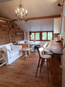 a living room with a white couch and a table at Studio Chic mit Whirlpool in Wildhaus