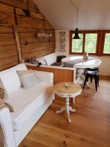 a living room with a couch and a table at Studio Chic mit Whirlpool in Wildhaus