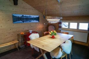 4-Bett- Ferienwohnung Brachli في انترتكيرشن: غرفة طعام مع طاولة وكراسي خشبية