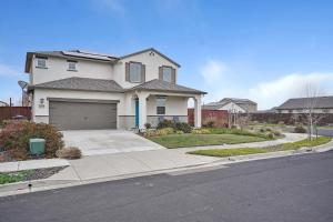 a white house with a garage on a street at #stayRioVista Luxury-Entire House-near river -Hot Tub in Rio Vista