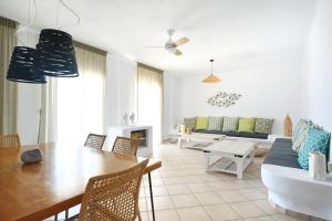 a living room with a table and a couch at Sea Breeze Mykonos in Panormos Mykonos