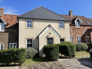 a house with bushes in front of it at Coral Shores - Part of the The Bay Filey Holiday Village with pool, gym and direct beach access, pub, restaurant, tennis and meadows walks in Filey