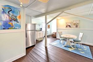 a kitchen with a table and a refrigerator at Historic Swansboro Studio with Intracoastal View! in Swansboro
