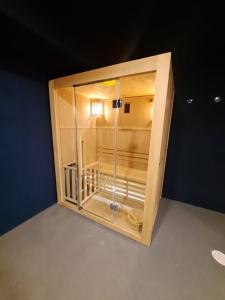 a wooden enclosure with a glass door in a room at RK Farallón Canteras in Las Palmas de Gran Canaria