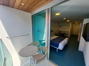 a room with a bed and a table and chairs at RK Farallón Canteras in Las Palmas de Gran Canaria