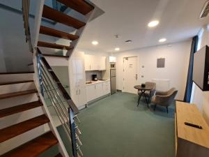 a staircase leading to a kitchen and a living room at RK Farallón Canteras in Las Palmas de Gran Canaria