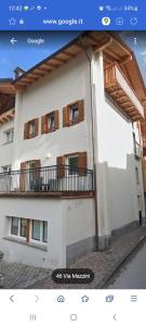 a building with a balcony on the side of it at RESIDENZA CADORINA in Calalzo