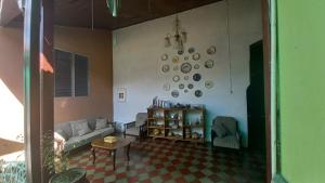 a living room with a couch and plates on the wall at Casa Vieja Guest House in Santa Ana +56 photos