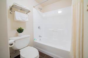 a bathroom with a toilet and a shower at Turlock Inn in Turlock