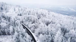an aerial view of a snow covered forest with a train track at ApartView Premium by Rent like home in Wisła