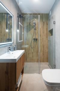 a bathroom with a shower and a sink and a toilet at Holiday Baltic Sun in Sztutowo +21 photos