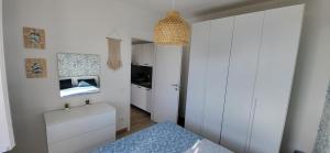 a small bedroom with white cabinets and a bed at Sull'Onda in Scalea +36 photos
