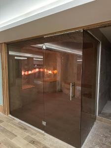 a glass door in a room with a fireplace at Apartman Pleasure M4 Milmari Resort in Kopaonik