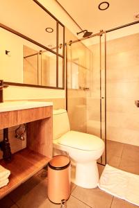 a bathroom with a toilet and a glass shower at HOTEL FENCE in Medellín