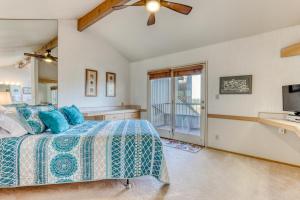 a bedroom with a bed with blue pillows and a tv at Robin Court Retreat in Redmond