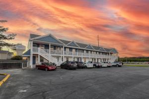 a large building with cars parked in a parking lot at Rehoboth Beach House --- 20494 Coastal Highway Unit #9 in Rehoboth Beach