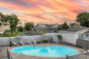 a large swimming pool with chairs and a fence at Rehoboth Beach House --- 20494 Coastal Highway Unit #9 in Rehoboth Beach