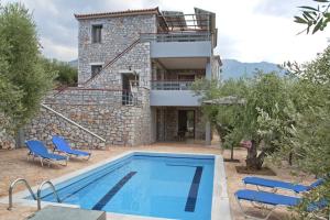 a villa with a swimming pool in front of a house at Villa Niobe in Riglia