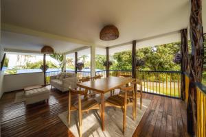 a dining room with a table and chairs on a balcony at Finca el Bosque in Montenegro