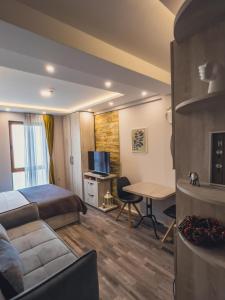 a hotel room with a bed and a desk at Milmari Premier - Daisy Apartments in Kopaonik +5 photos