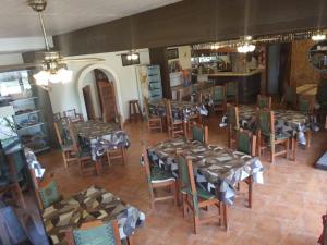 uitzicht op een restaurant met tafels en stoelen bij Hosteria Quime in La Lucila del Mar