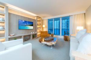 a living room with a couch and a tv at Oceanview Private Condo at 1 Hotel & Homes -1010 in Miami Beach