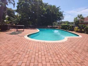 a small swimming pool on a brick patio at Beach View in Oslo Beach