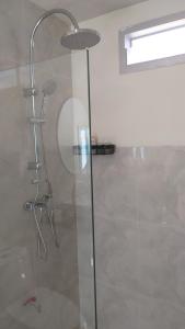 a shower with a glass door in a bathroom at RadHut in Chalong