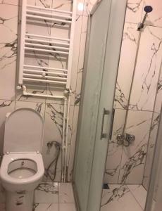 a small bathroom with a toilet and a shower at Lovely 2 bedroom vacation rental unit in Yalova