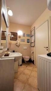 a bathroom with a tub and a toilet and a sink at Tropical Morabeza Apartment Santa Maria in Santa Maria