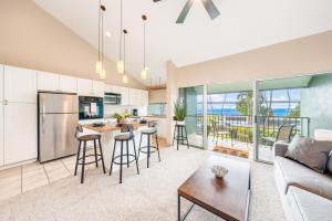 a kitchen and living room with a couch and a table at Kihei Park Shores 13 in Kihei