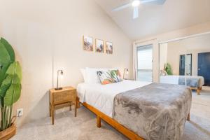 a bedroom with a bed with a night stand and a window at Kihei Park Shores 13 in Kihei +32 photos