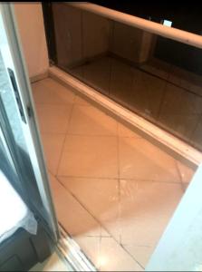 a room with a glass door and a tile floor at Furnished Apartment in Dubai