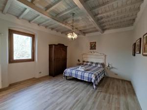 a bedroom with a bed with a checkered blanket at Villa Le Balze in Reggello