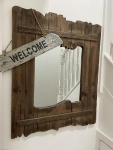 a mirror with a welcome sign hanging on a wall at Lees Plaice - Part of the The Bay Filey Holiday Village with pool, gym and direct beach access, pub, restaurant, tennis and meadows walks in Filey +36 photos