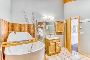 a bathroom with a tub and a sink at Six Mountain View in Sisters +36 photos