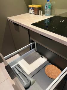a kitchen with a counter with a knife and a drawer at Apartament WARSZAWA Kolejowa HUB EXPO in Warsaw
