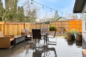 a patio with a table and chairs and a fence at Hayward Home in Eugene