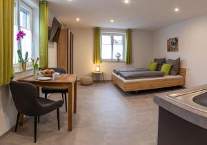 ein Wohnzimmer mit einem Bett und einem Tisch in der Unterkunft Apartment Alte Raiffeisenkasse Rothenburg ob der Tauber in Rothenburg ob der Tauber