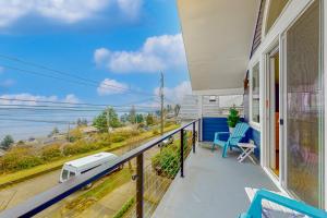 a balcony with a view of the ocean from a house at Lake Washington Adventures in Seattle