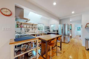 a large kitchen with a wooden table and a counter at Lake Washington Adventures in Seattle