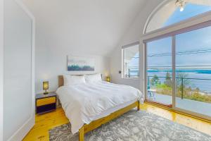 a bedroom with a bed and a large window at Lake Washington Adventures in Seattle