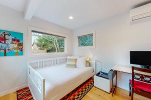 a white bedroom with a bed and a window at Lake Washington Adventures in Seattle