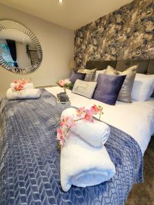 a bedroom with a large bed with pillows and a mirror at Studio Apartment The Den Colnbrook in Colnbrook