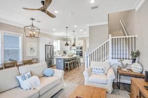 a living room with a white couch and a kitchen at Come Sail Away in Inlet Beach