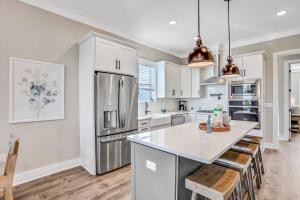 a kitchen with white cabinets and a white counter top at Come Sail Away in Inlet Beach