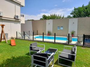 un patio con sillas y una piscina en Apartamentos Ref en Salta